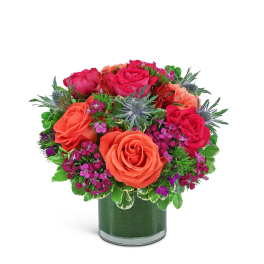 Bouquet of orange and pink roses in a glass vase
