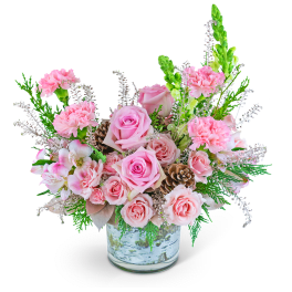 Pink roses and carnations in a glass vase with pinecones