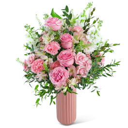 Pink roses and carnations in a tall pink vase