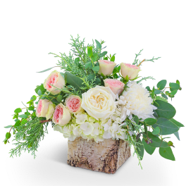 Pink and white roses in a birch bark container