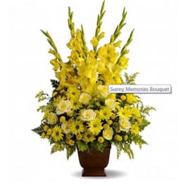 Tall yellow floral arrangement in a brown urn vase
