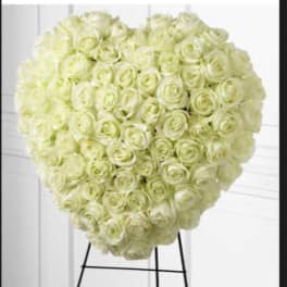 Heart-shaped arrangement of pale cream roses on a stand