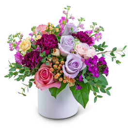 Mixed bouquet of roses and carnations in a white vase
