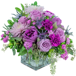 Lavender and purple mixed bouquet in a square glass vase