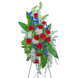 Tall standing floral spray with red roses, white blooms, and blue flowers