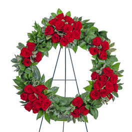 Red rose funeral wreath on a metal stand