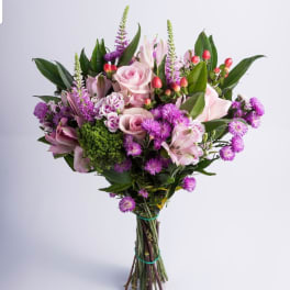 Hand-tied bouquet of pink roses and purple flowers