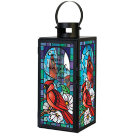 Black metal lantern with stained-glass-style red cardinals, white flowers, and a memorial quote.