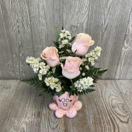 Pink roses and white daisies arranged in a pink cartoon vase