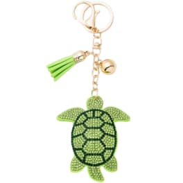 Green turtle keychain with gold hardware and a tassel charm