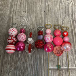 Decorative heart-topped picks with colorful beaded and patterned spheres