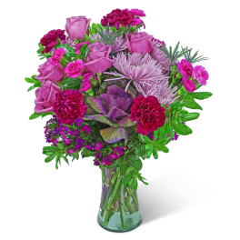 Pink roses and magenta carnations in a clear glass vase