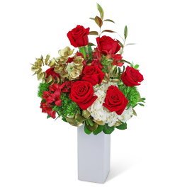 Red roses and white flowers arranged in a tall white vase
