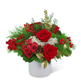 Red roses and red flowers in a white vase with pine and berries