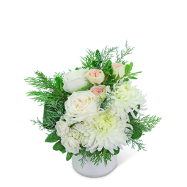 White and blush flowers arranged in a white vase