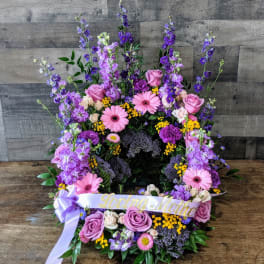 Tall purple and pink floral wreath with Loving Mother ribbon