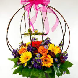 Colorful flower basket with a pink ribbon bow and birdcage topper