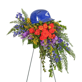 Floral tribute with red roses and purple flowers topped by a blue hard hat