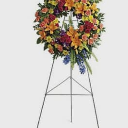Standing floral wreath on an easel with mixed bright flowers