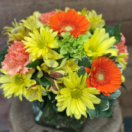 Bouquet of yellow and orange daisies with pink carnations