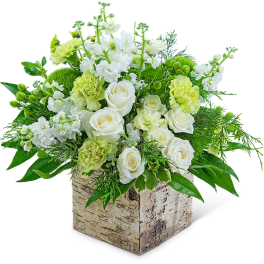 White roses and pale green carnations in a birch box
