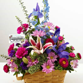 Colorful mixed flower arrangement in a woven basket
