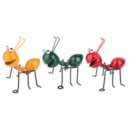 Three colorful metal ant figurines on a white background