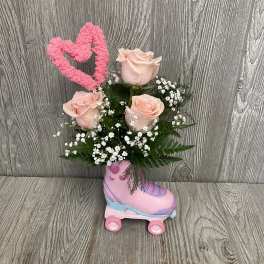 Pink roses in a roller skate planter with a heart topper
