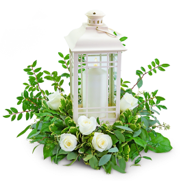 White lantern centerpiece with roses and greenery