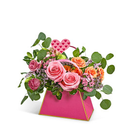 Pink and peach rose arrangement in a bright pink box with a heart pick