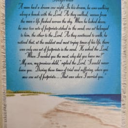 Fringed wall hanging with a beach scene and printed poem text