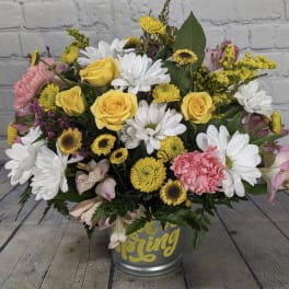 Yellow roses and white daisies in a metal bucket