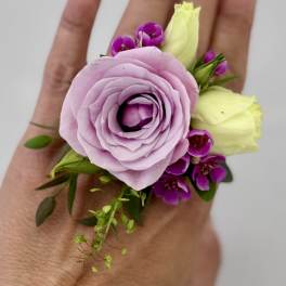 Lavender rose boutonniere with small purple blooms and pale yellow buds