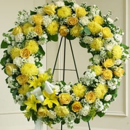 Yellow and white floral wreath on a black easel