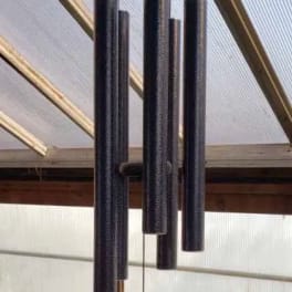 Black hanging wind chime with long tubular pipes