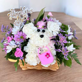 White and pink flower basket with a teddy bear and Mother's Day sign