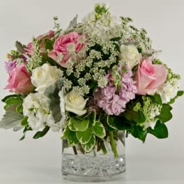Pink and white roses in a clear glass vase