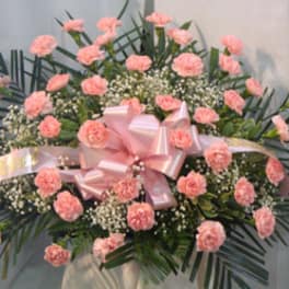 Pink carnation floral spray with a large pink bow