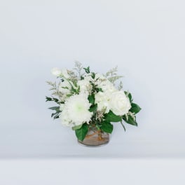 White floral arrangement in a clear glass vase