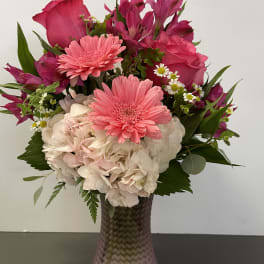 Pink and white mixed bouquet in a textured glass vase