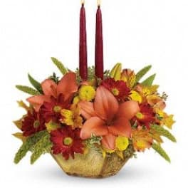 Autumn floral centerpiece with two red taper candles