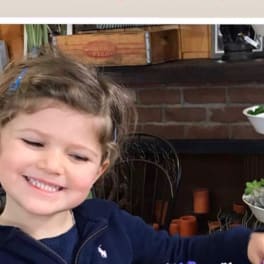 Smiling child holding a colorful mixed flower bouquet