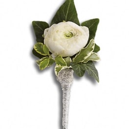 White ranunculus boutonniere with green leaves