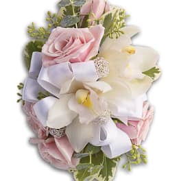Pink roses and white orchids with a white ribbon