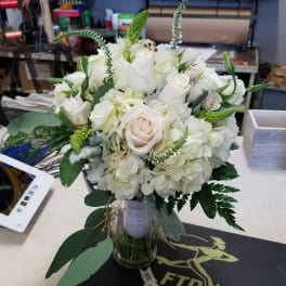 White rose and hydrangea bouquet in a clear glass vase