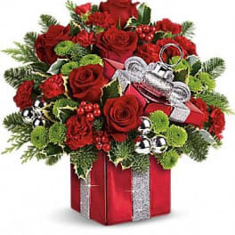 Red roses and carnations in a gift box with silver ribbon