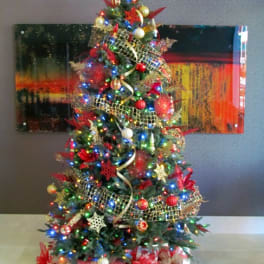 Decorated Christmas tree with lights, ornaments, and wrapped gifts underneath