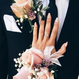 Boutonniere and wrist corsage with pale pink roses on formal attire