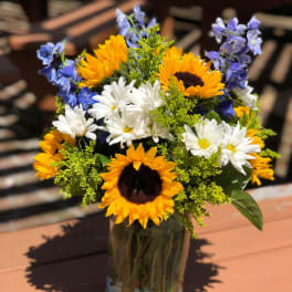 Sunflower and daisy bouquet in a glass vase