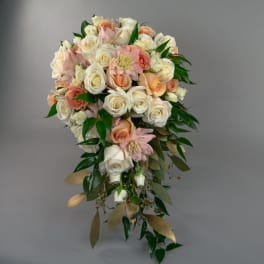 Cascade bouquet of cream and blush roses with greenery